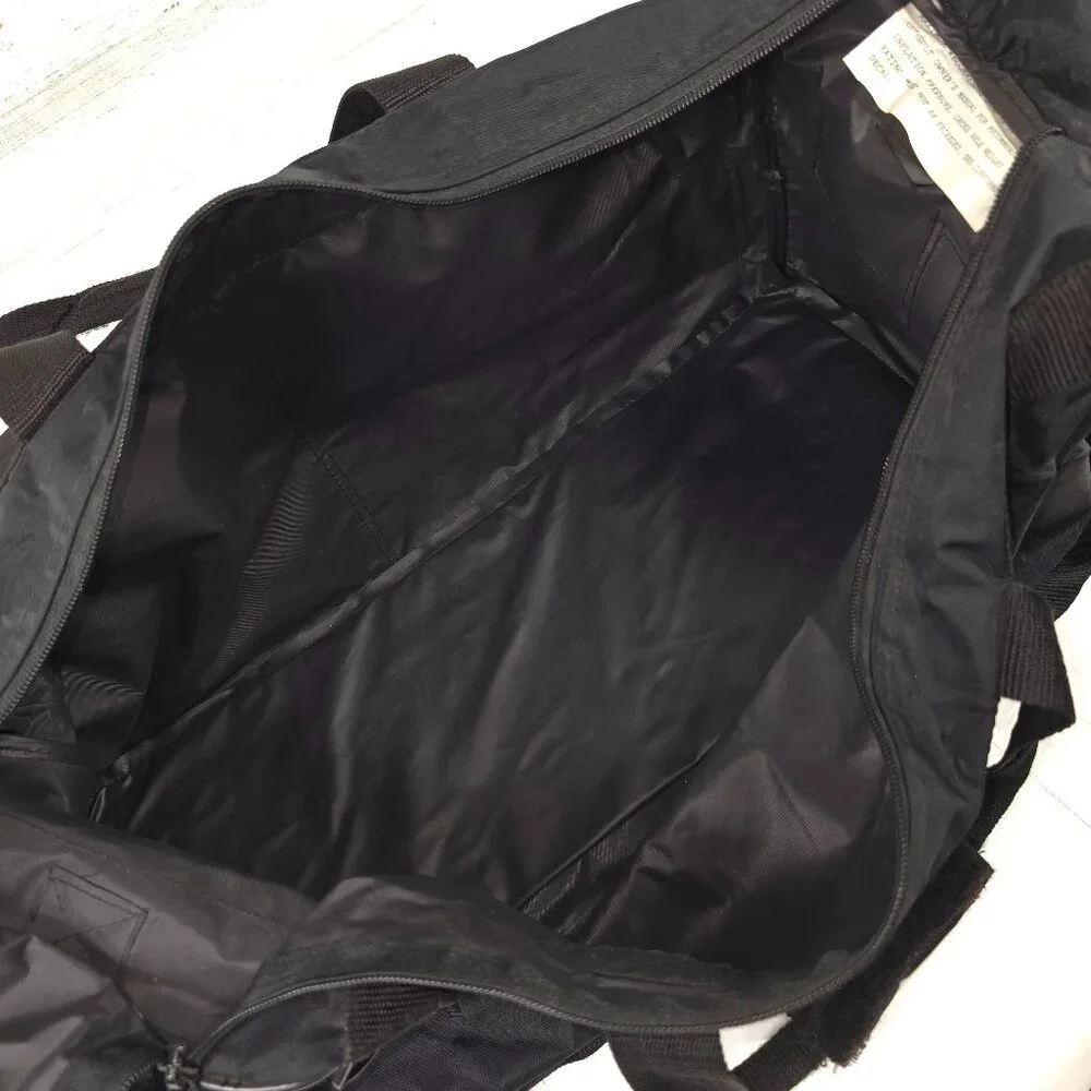VINTAGE HARLEY DAVIDSON AN AMERICAN LEGEND BLACK DUFFLE BAG WITH SHOULDER STRAP.